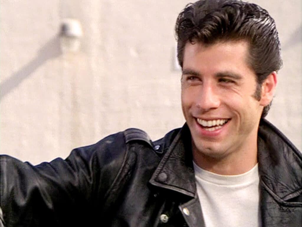 How old was John Travolta when he appeared in Grease